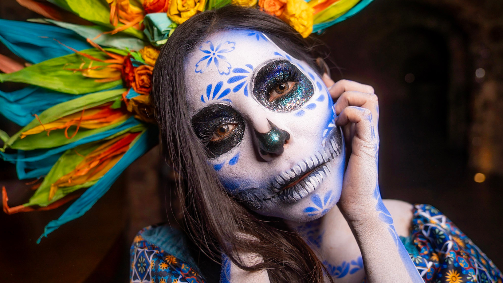 A woman with sugar skull face paint in celebration of the Day of the Dead.