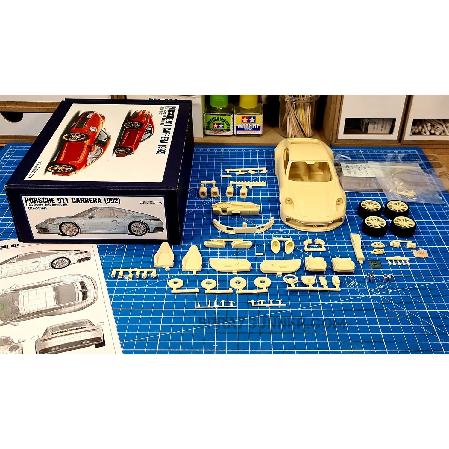 Porsche 911 Carrera 2021 ALPHA MODEL 1/24 scale model vehicle kit with a well crafted red and gold rim reproduction. Perfect for fans of model cars.